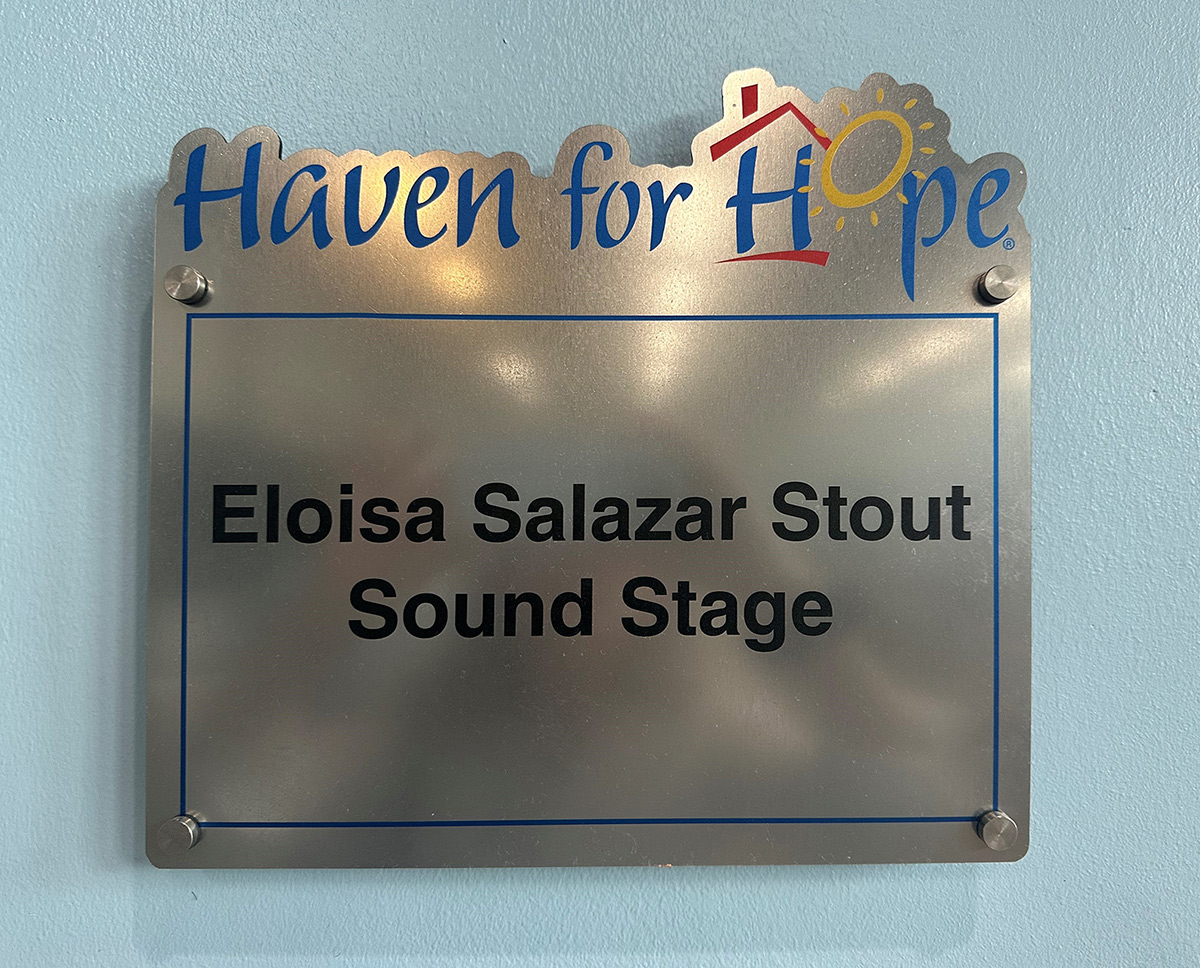 MC-LC-in-front-of-Eloisa-Salazar-Stout-Sound-Stage-Sign